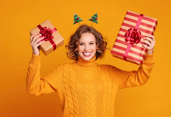 Happy Young Woman Sweater Headband Showing Wrapped Gifts Looking Camera — Stock Photo, Image