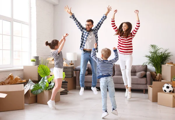 Full Length Excited Parents Kids Raising Arms Leaping Carton Boxes — Stock Photo, Image