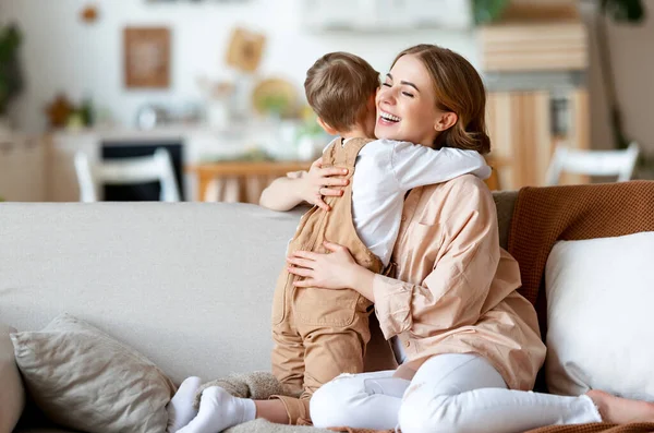 Nadšení Dospělá Žena Usmívá Objímající Chlapce Zatímco Odpočívá Gauči Doma — Stock fotografie