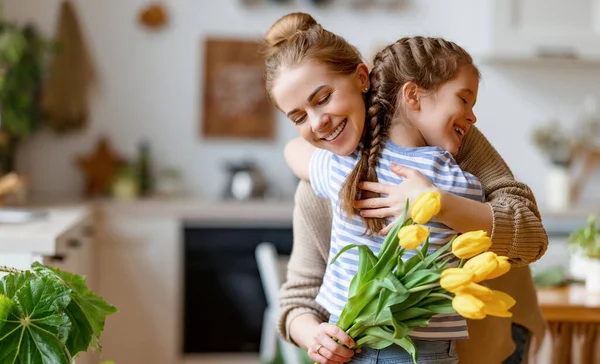 Szerető Kislány Ölelés Boldog Anya Üdvözlő Csokor Sárga Tulipán Alatt — Stock Fotó