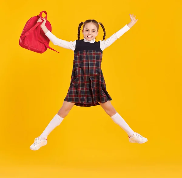 Full Length Girl Trendy School Uniform Holding Bagpack Jumping Yellow — Stock Photo, Image