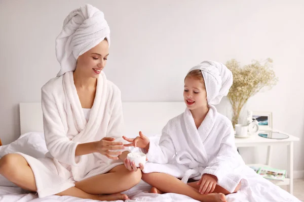 Cheerful Mother Daughter Smiling While Sitting Bed Smearing Cream Face — ストック写真