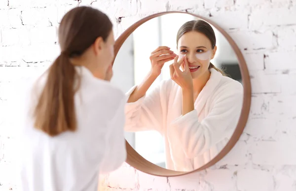 Happy Young Female White Bathrobe Applying Moisturizing Patches Eyes Front — Stock Photo, Image