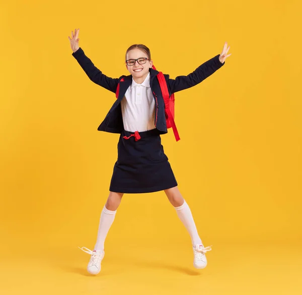 Full Body Happy Preteen Schoolgirl Black Uniform Glasses Backpack Jumping — Stock Photo, Image