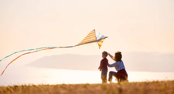 Back View Happy Family Mother Son Launch Kite Nature Sunset — Stock Photo, Image