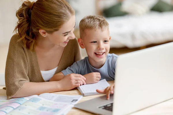 Cheerful Little Schoolboy Headphones Doing Exercises Copybook While Studying Remotely — Stock Photo, Image