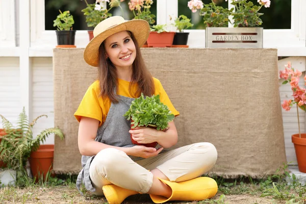 Delighted Female Gardener Potted Plant Smiling Looking Camera While Sitting — Stock Photo, Image