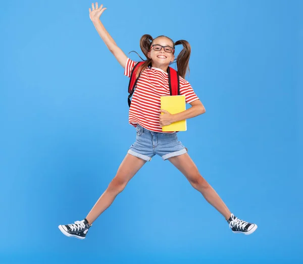 Full Body Happy Energetic Primary Schoolgirl Wearing Casual Clothes Holding — Stock Photo, Image