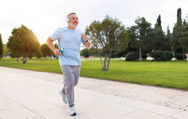 Full Length Photo Happy Senior Man Headphones Sportswear Jogging Running — Stock Photo, Image