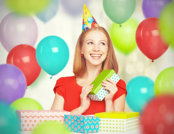 Happy girl celebrating birthday with balloons and gifts — Stock Photo, Image