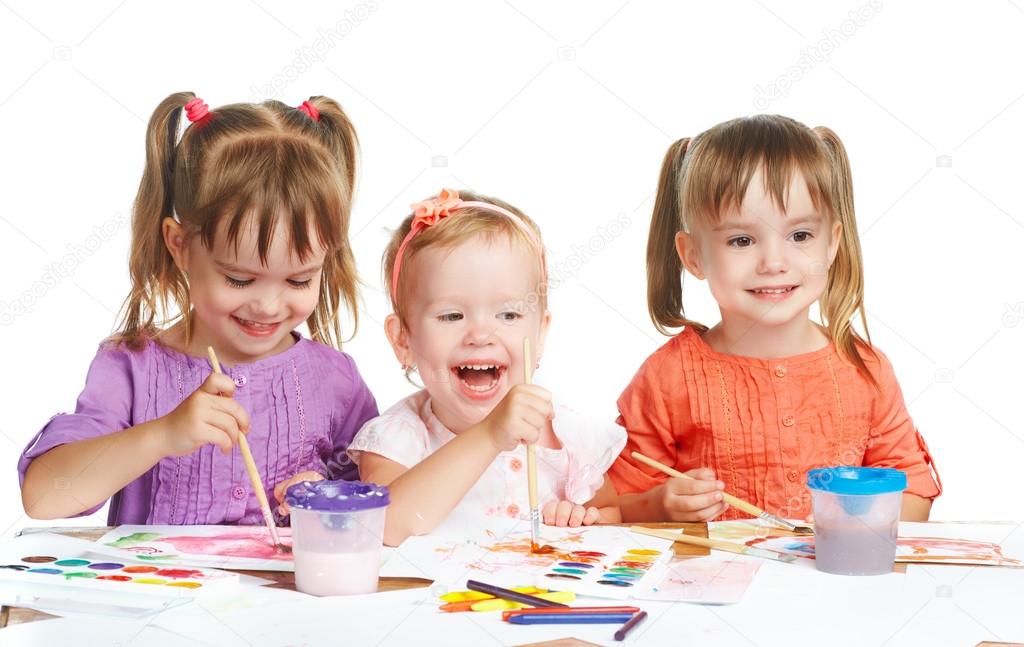 happy little girl in kindergarten draw paints on white background