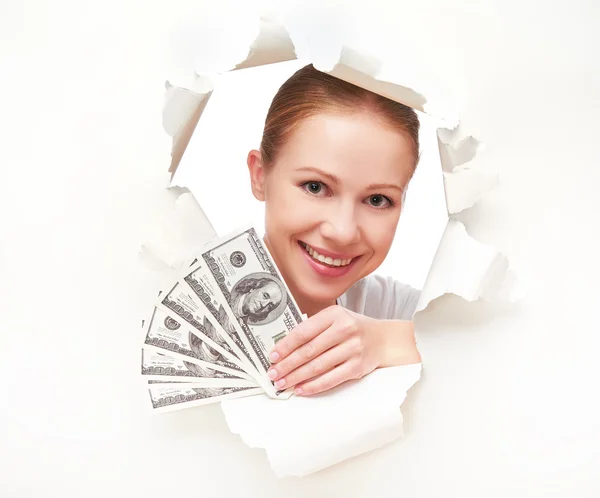 Financial concept, happy woman with money in hands dollorov peeking through a hole in a blank white paper — Stock Photo, Image