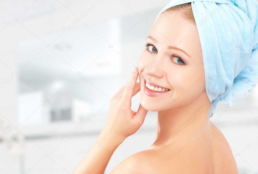 skin care. young beautiful healthy girl in towel in bathroom