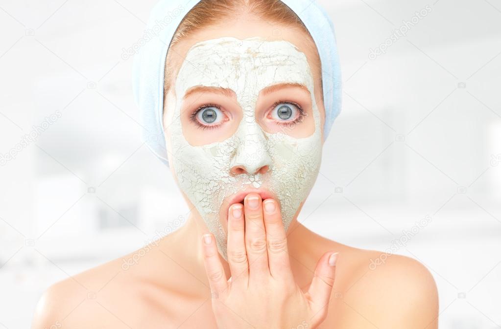 funny young woman and facial skin care mask