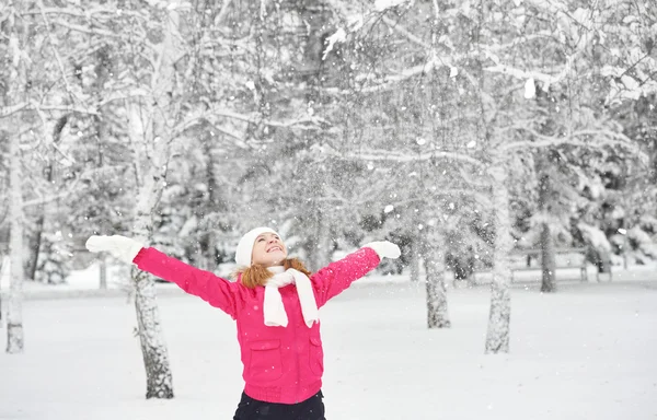 Happy girl enjoying life and throws snow at winter outdoors — Stock Photo, Image