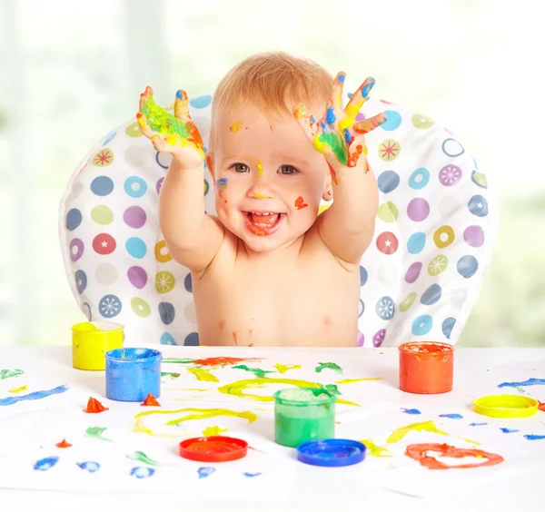 Happy baby child draws with colored paints hands — Stock Photo, Image