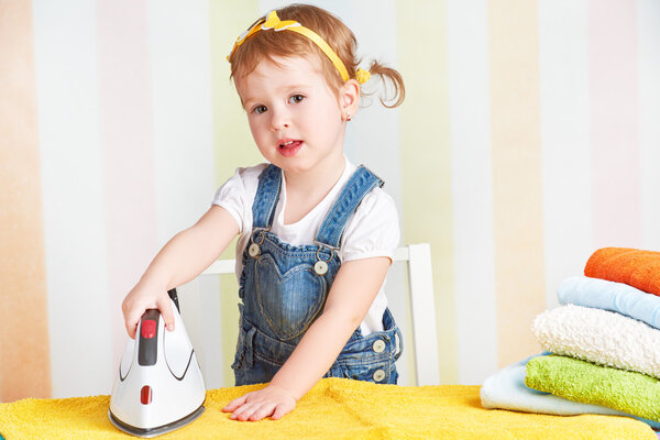 cute  baby girl housewife iron clothes iron, is engaged in domes