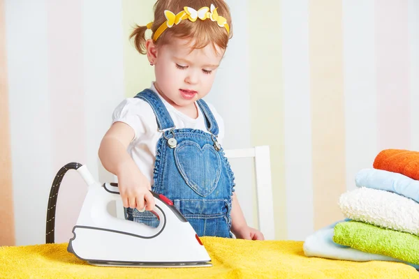 Söt baby flicka hemmafru järn kläder järn, bedriver kupoler — Stockfoto