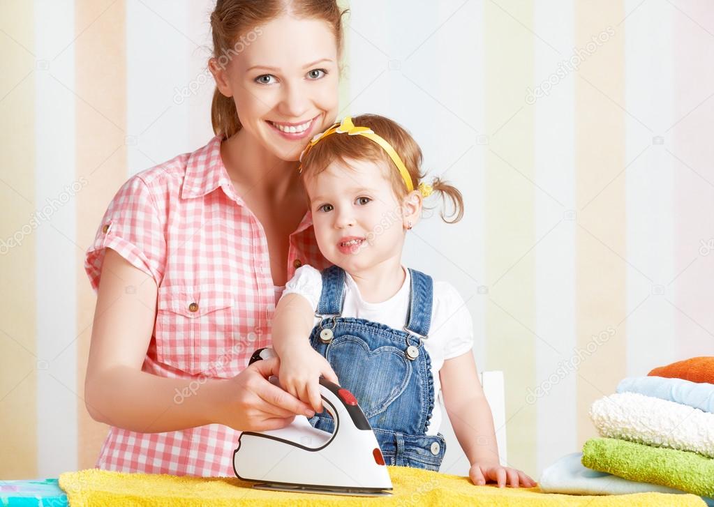 family mother and baby daughter together engaged in housework ir