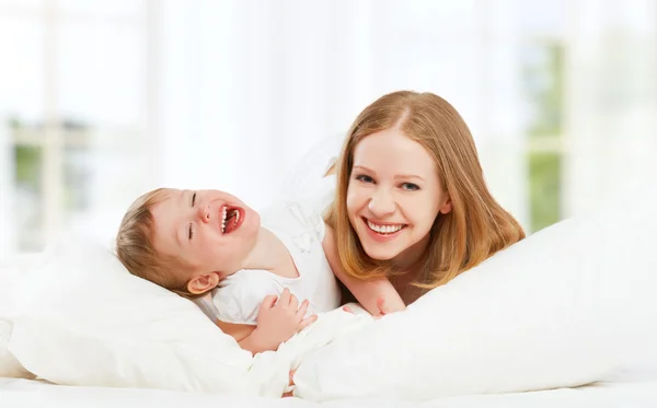 Happy family mother and baby daughter playing and laughing baby — Stock Photo, Image