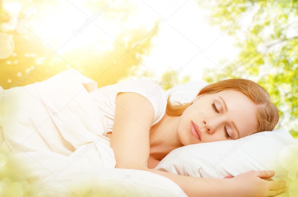 concept of rest and relaxation. woman sleeping in bed on the bac