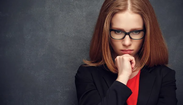 Serious stern woman teacher at blackboard — ストック写真