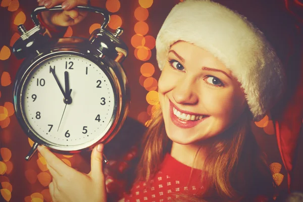 Merry Christmas! woman in Christmas hat with alarm clock — Stock Photo, Image