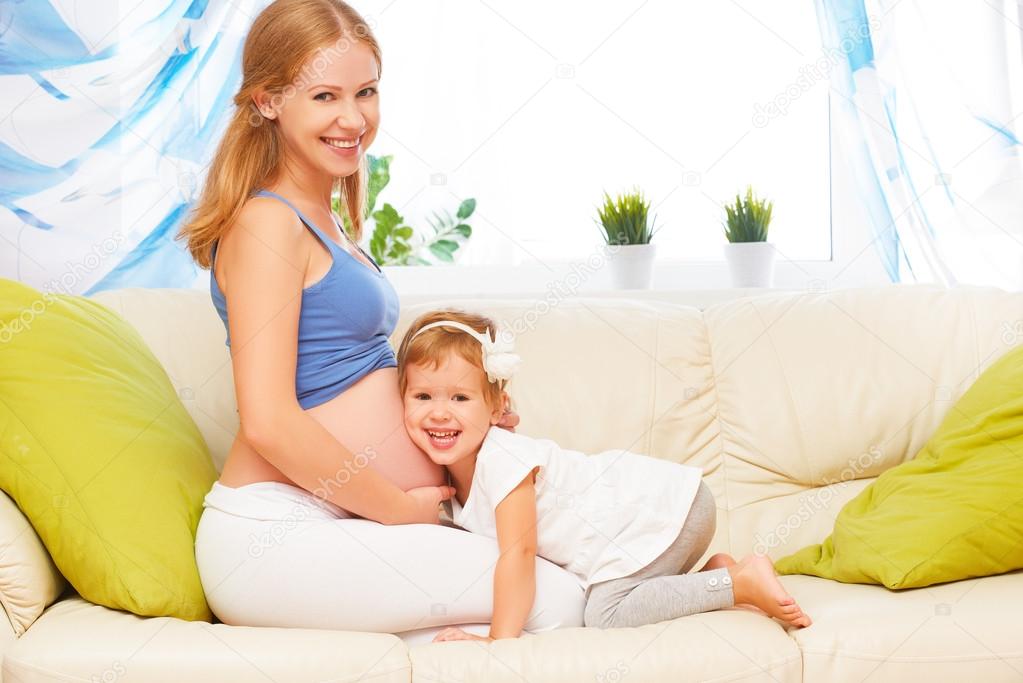 happy family. Pregnant mother and baby daughter having fun relax