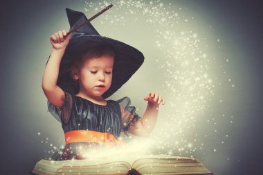 Halloween. cheerful little witch with a magic wand and glowing b clipart