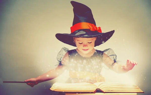 Halloween. cheerful little witch with a magic wand and glowing b — Stock Photo, Image