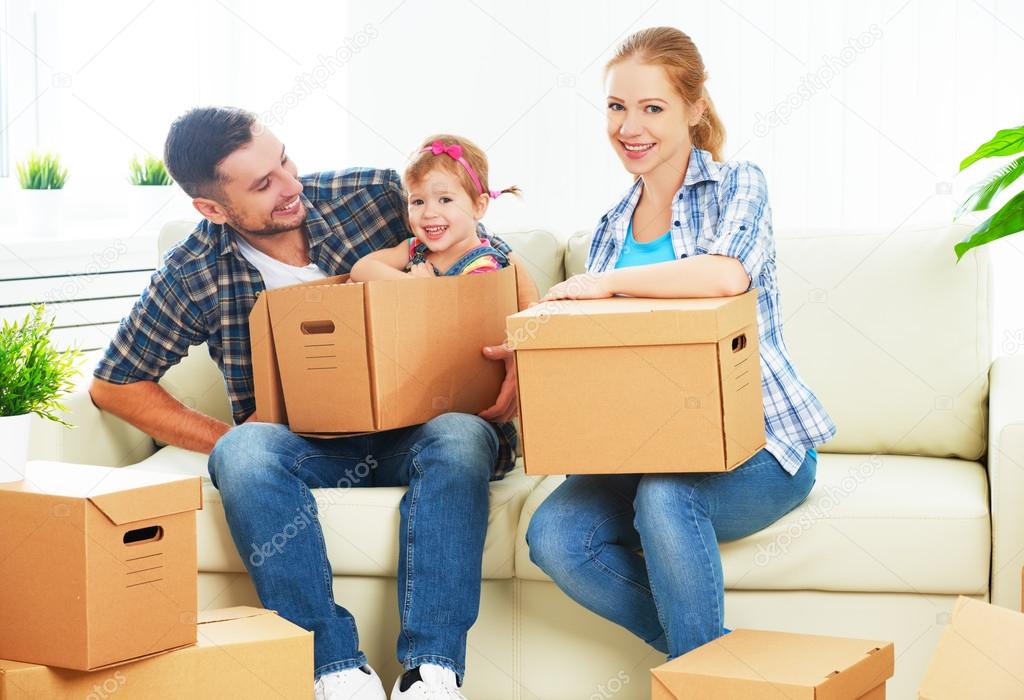 moving to new home. Happy family with cardboard boxes