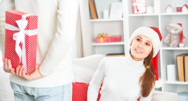 Christmas gift. man gives a woman gift present box — Stock Photo, Image