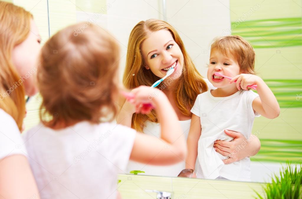 happy family mother and daughter child brushing her teeth toothb