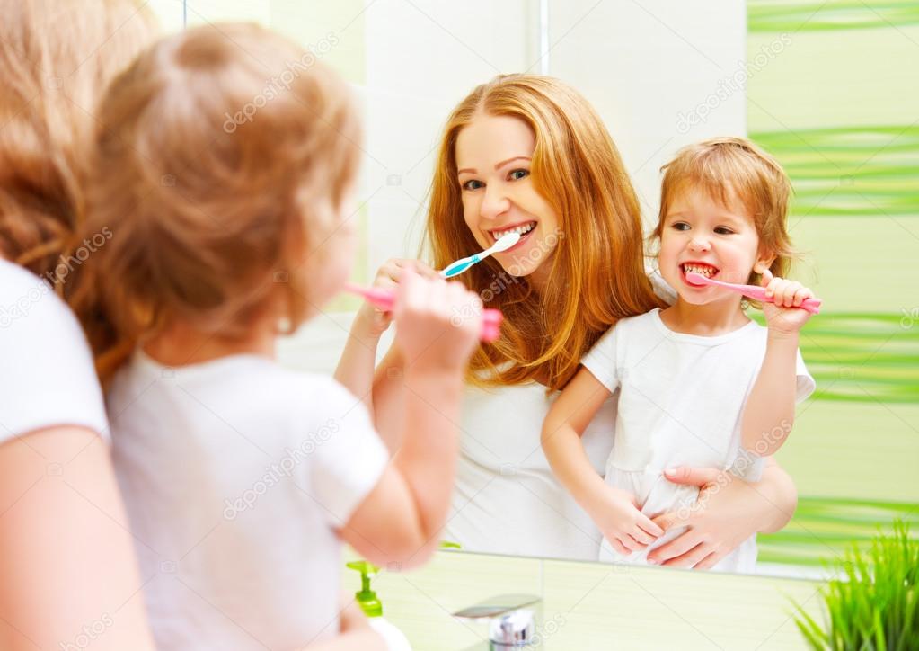 happy family mother and daughter child brushing her teeth toothb