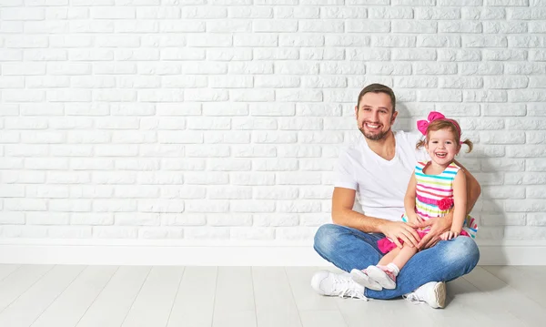 Családi apa-gyermek lánya egy üres fehér tégla fal — Stock Fotó