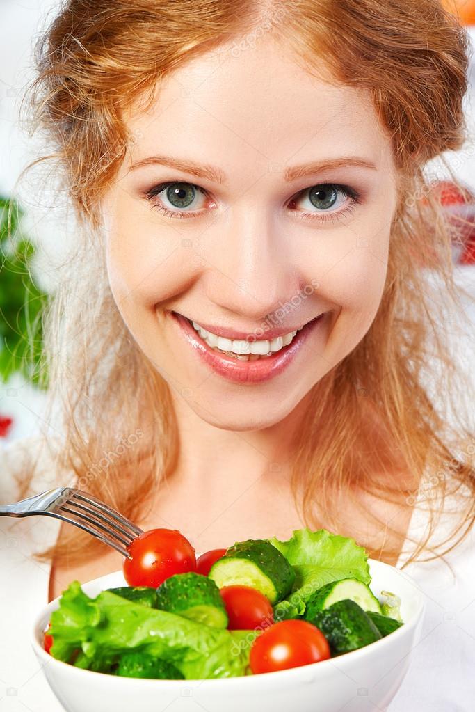 woman eats healthy food vegetable vegetarian salad about refrige