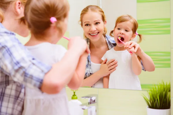Família feliz mãe e filha criança escovando os dentes denteb — Fotografia de Stock