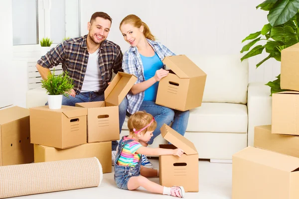 Moving to new home. Happy family with cardboard boxes — Stock Photo, Image