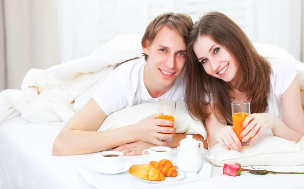 Loving couple having breakfast in bed Royalty Free Stock Images