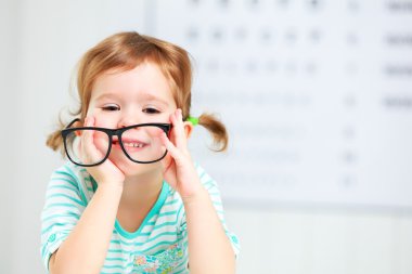 concept vision testing. child  girl with eyeglasses clipart