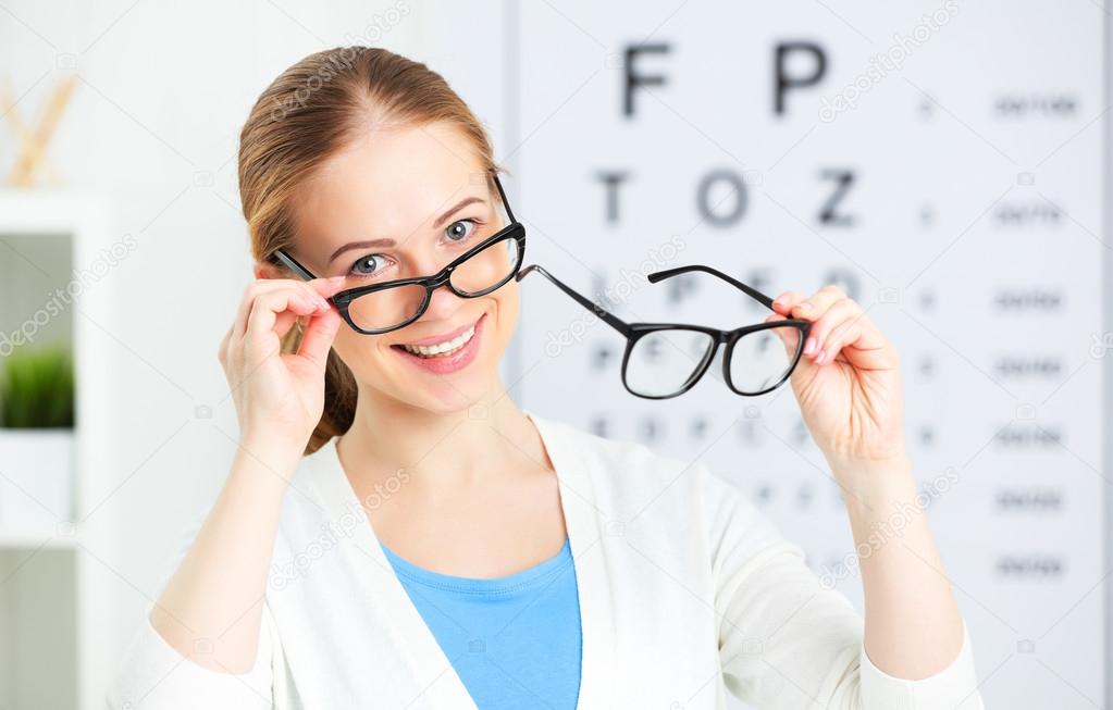 eyesight check. woman choose glasses at doctor ophthalmologist o