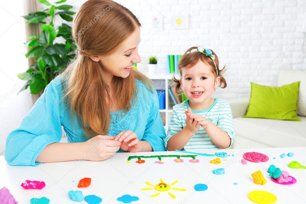 child with his mother sculpts from clay