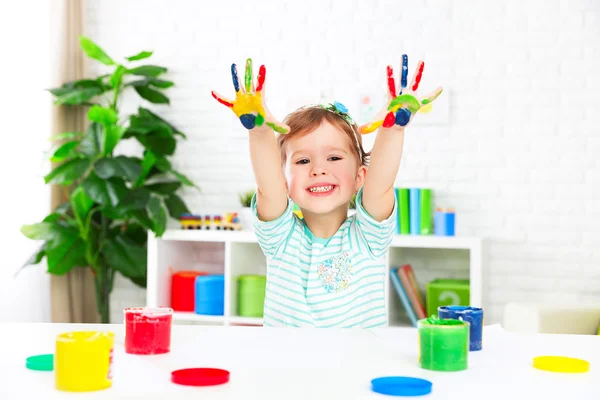 Hands in colored paint  happy child girl — Stock Photo, Image