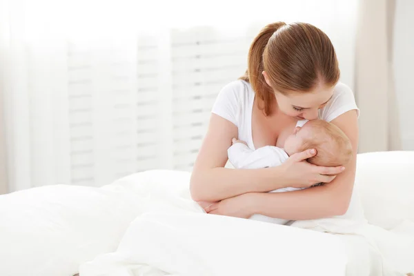 快乐家庭的刚出生的婴儿在白色的拥抱母亲 — 图库照片