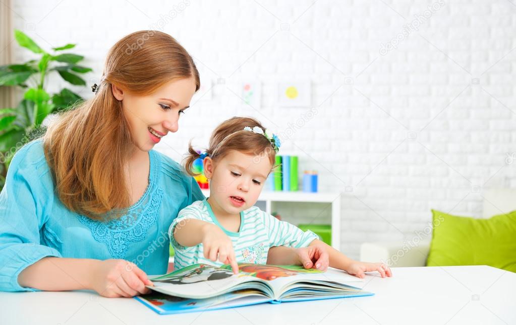 mother and child reading  book at home