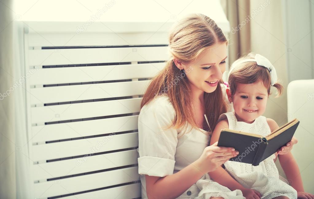happy family mother child little girl reading  book 