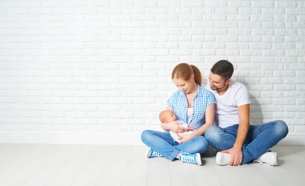 Happy family mother, father of a newborn baby on floor near blan — Stock Photo, Image