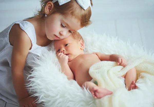 Children sister and brother  newborn baby on a light — Stock Photo, Image