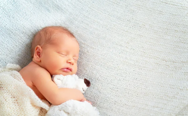 Lindo recién nacido bebé duerme con juguete osito de peluche — Foto de Stock