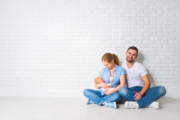 Ευτυχισμένη οικογενειακή μητέρα, ο πατέρας της ένα νεογέννητο μωρό στο πάτωμα κοντά σε κενές — Φωτογραφία Αρχείου